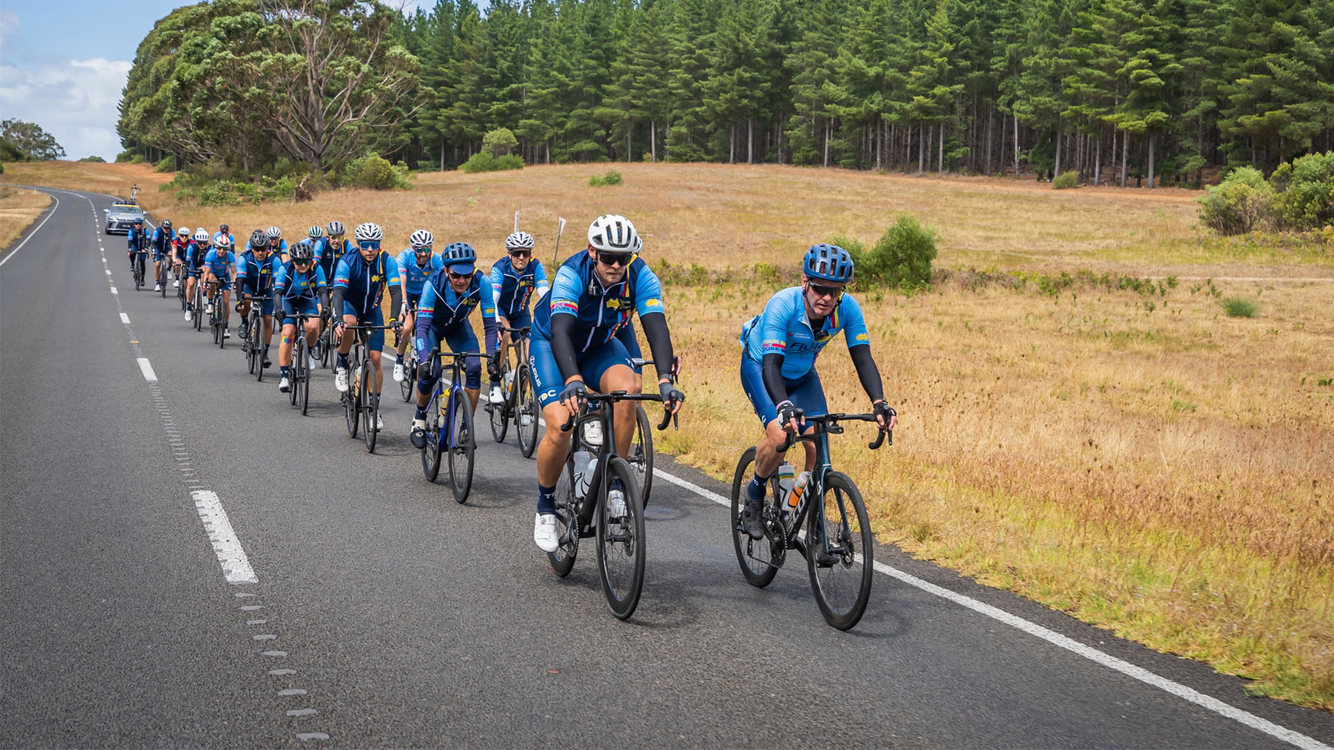 Cyclists ride along a scenic road for Tour de Cure