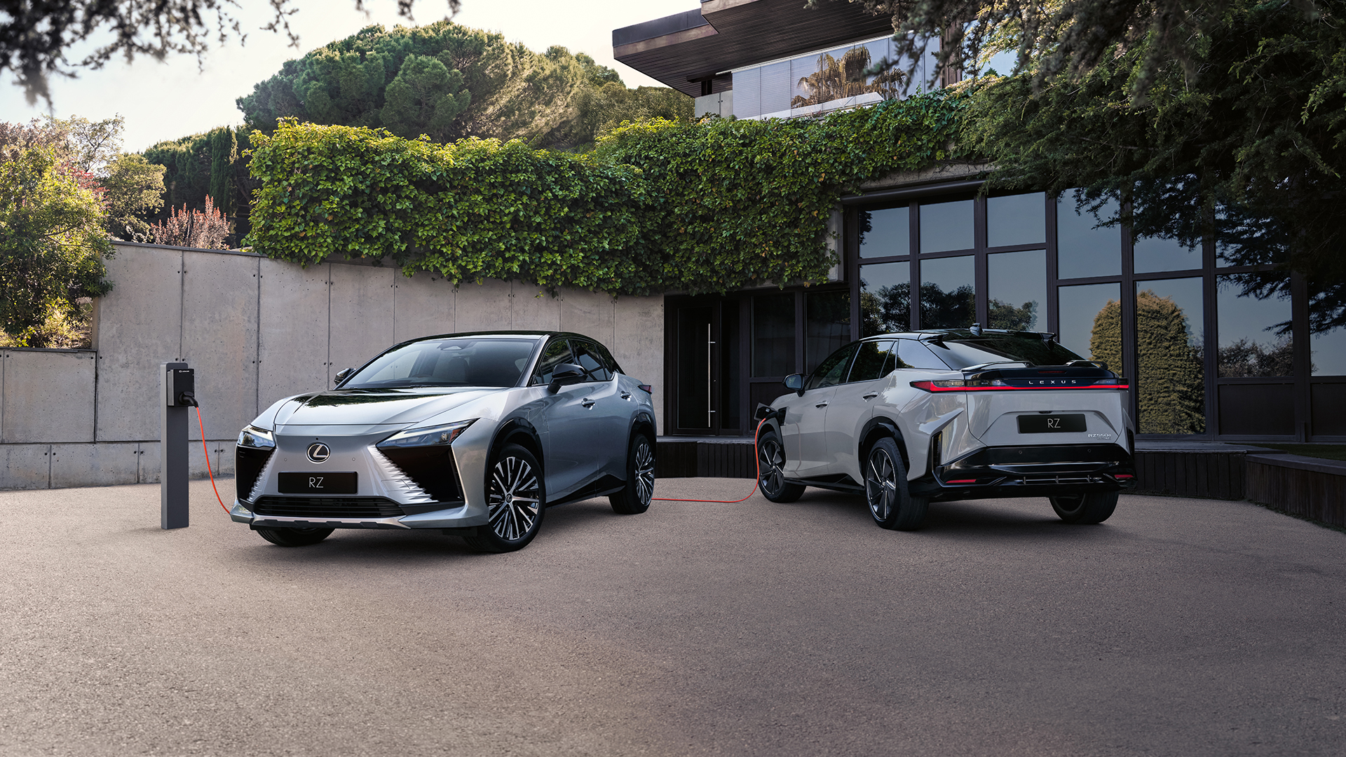 Lexus RZ vehicles charging on a driveway