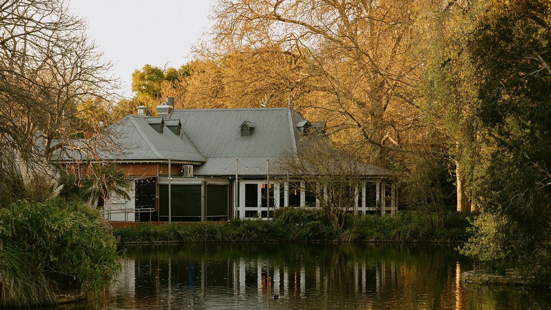 Restaurant by the lakeside with autumn trees in the background. Restaurant is Botanic, a fine dining partner of Lexus, in Adelaide, Australia. 