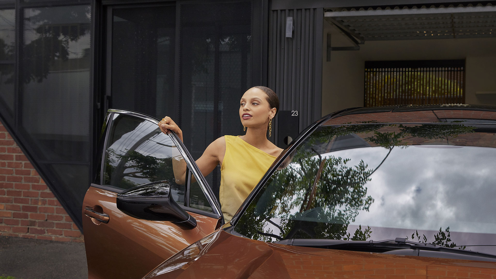 A woman in yellow exits a vehicle