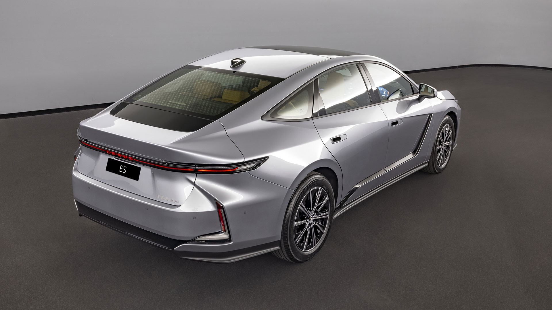 The Lexus ES luxury sedan in silver in a studio setting